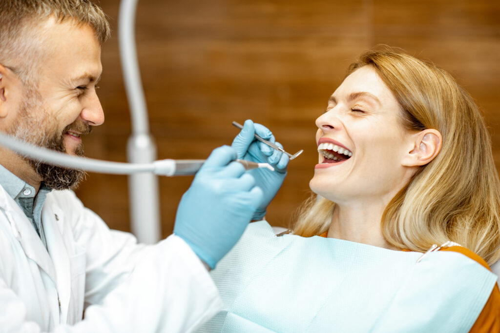 adult patient with dentist smiling during a medical consultation