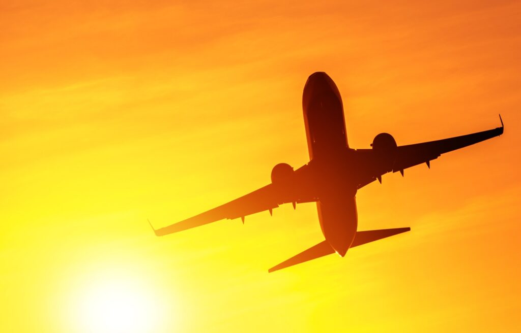 airplane taking off in the sun